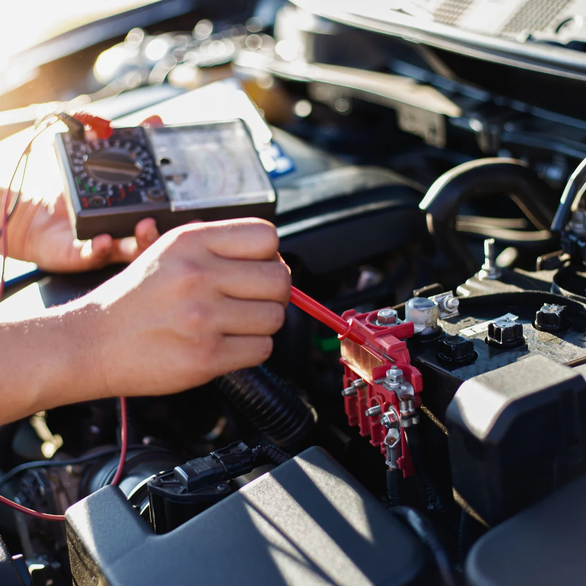 Auto repair shop checking engine bay wiring
